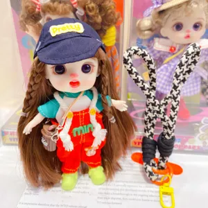 Vinyl doll pendant detail view, cute movable fashion toy keychain with stylish outfit.