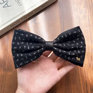 Retro floral bow hair clip with cute metallic dog charm, elegant black spring clip for women.
