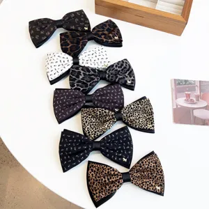 Retro floral and leopard print bow hair clips with cute metal dog charm for women autumn.