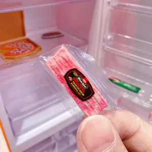Detail shot of mini bacon food toy in transparent packaging for dollhouse miniature play.