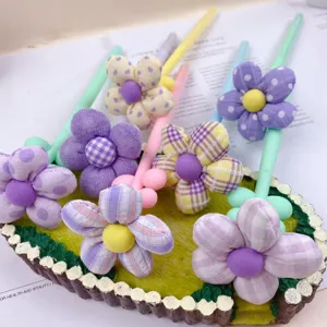 Close-up detail of creative fabric flower ballpoint pens featuring vibrant dopamine shades.