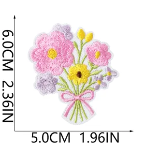 Detail shot of embroidered flower bouquet patch with cute pink bow and vibrant colors.