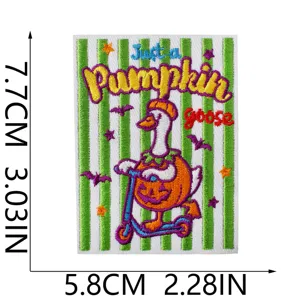 Close-up of a cute pumpkin duck embroidered patch with vibrant green stripes detail.