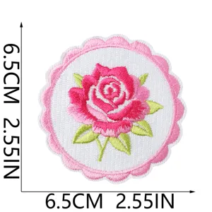 Detailed view of round pink rose embroidery patch, floral iron-on badge for clothes jeans.