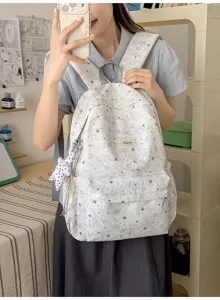 Detail view of the cute star print school backpack, showing the large capacity and pendant.