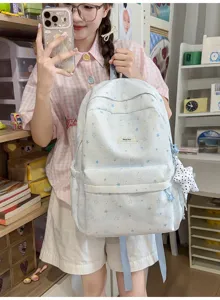Detail view of the cute star print student backpack showing front pocket, fabric texture, and strap.