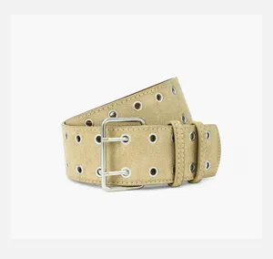 Close-up of wide metallic gold grommet belt detail with double pin buckle and metal eyelets.