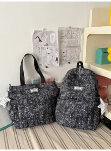 Detailed view of dark grey star print school backpack and tote bag set with front pocket.