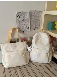 Detailed view of the cute star printed canvas backpack and tote bag set in yellow style.