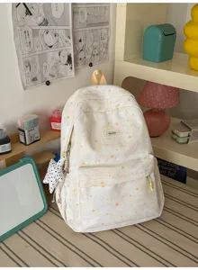 Cute star print canvas school backpack detail showing front pocket and golden zipper