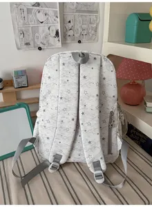 Detailed back view of grey star printed school backpack with adjustable straps and side pocket.