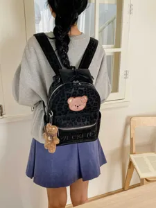 Cute black leopard velvet backpack for women with bear patch and bow, stylish school bag.
