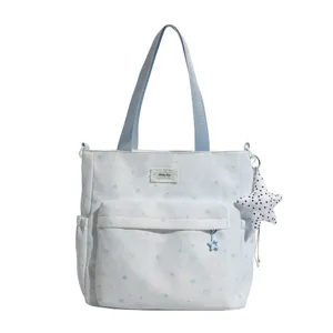 Light blue star print canvas tote bag, large capacity shoulder bag with front pocket.