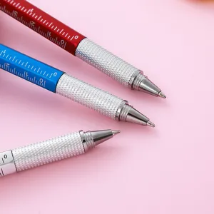 Multi-functional tool ballpoint pen with ruler scale and metal grip, clean pink background display.