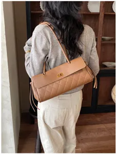 Detailed view of women's retro quilted PU leather shoulder bag in caramel brown.