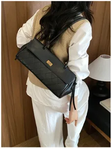 Detail view of the black quilted PU leather shoulder bag featuring a stylish golden twist lock.