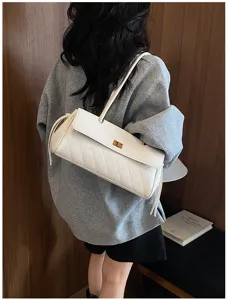 Close-up detail of white textured pu leather shoulder bag with chic turn lock closure.