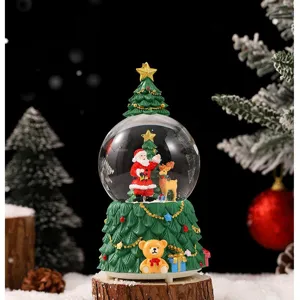Christmas tree snow globe music box with Santa Claus and cute bear base for holiday decor.