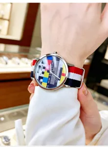 Trendy quartz watch with colorful TV test pattern dial and stylish red white blue canvas strap.