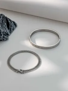 Stainless steel Roman numeral bangle and chain detail shot, niche high-end design, non-fading.