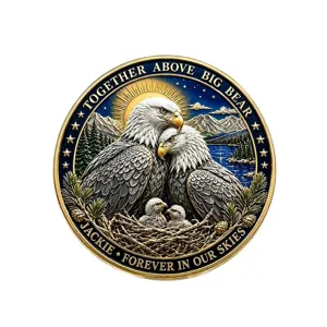 Memorial coin featuring bald eagle family design, intricate metal relief, collectible item.