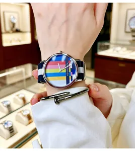 Colorful TV dial quartz watch with blue and white striped canvas strap for daily fashion detail