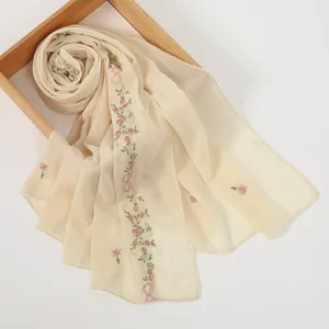 Close up view of the elegant beige chiffon long scarf featuring delicate pink floral embroidery.