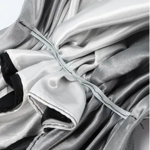 Close-up detail of gradient satin turban with elastic band and soft inner lining.