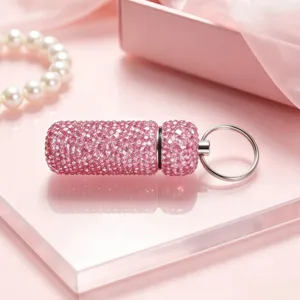 Pink rhinestone capsule keychain pendant, sparkling crystal car charm and bag accessory detail.