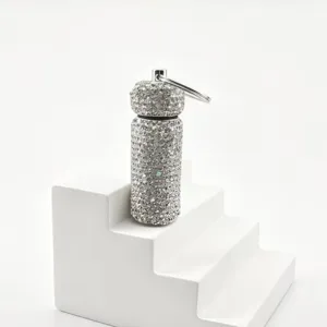 Rhinestone cylinder keychain detail shot showing sparkling crystal texture and metal ring.