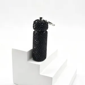 Detailed close-up view of the black rhinestone studded sub-packaging bottle keychain pendant.