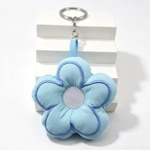 Blue puffy flower keychain detail, soft fabric five petal design with metal ring.