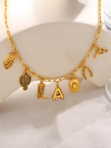 Detailed view of gold western charm necklace with cowboy boot, cactus and horseshoe pendants.