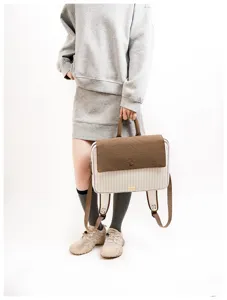 Stylish striped laptop backpack with brown flap, casual student school bag for daily commute.