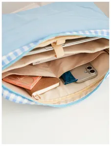 Blue and white gingham laptop sleeve with multiple inner compartments and secure zipper.