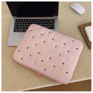 Pink quilted laptop sleeve with colorful embroidery details, soft protective case interior.