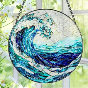 Detailed view of a round acrylic wave suncatcher hanging by a window, vibrant blue ocean art decor.