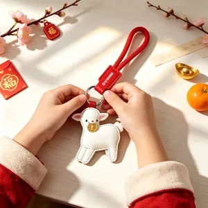 Cute white sheep keychain with red leather strap, festive New Year hanging ornament and charm.