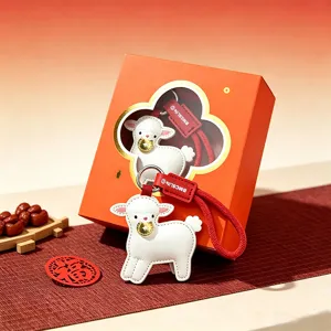 Cute white sheep leather keychain pendant with gold ingot for New Year gift bag charm.