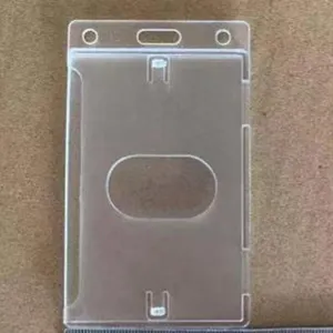 Transparent hard plastic ID card holder detail view showing clear badge protector with thumb slot.