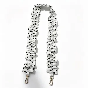 White polka dot scrunchie fabric strap for stylish handbag and phone lanyard with gold clasps.