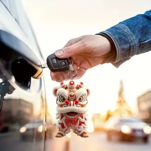 Closeup of Chinese lion dance keychain hanging on car key, detail shot in outdoor lighting.