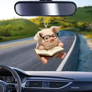 Cute reading pig car rearview mirror acrylic hanging ornament interior decoration detail shot.