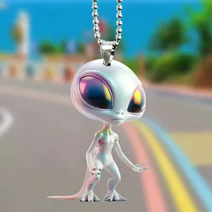 Close-up detail of the big-eyed alien pendant with iridescent eyes and metal ball chain.