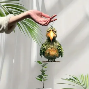 Close-up of a cute green bird acrylic pendant, perfect for car hanging or backpack decor.