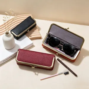 Detailed view of luxury leather kiss lock glasses case, vintage storage box for sunglasses.