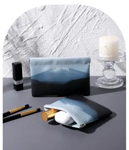 Detail shot of the mini portable cosmetic pouch with Mount Fuji landscape print and elastic closure.