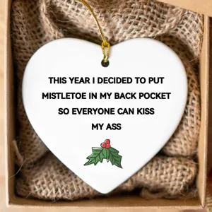 Funny Christmas heart ornament with humorous quote and mistletoe graphic for holiday decor.