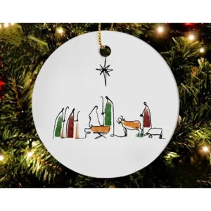 Detailed view of minimalist Nativity scene Christmas tree ornament hanging on festive branches.