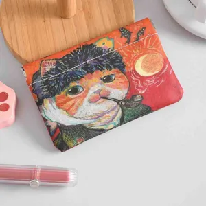 Detail shot of mini auto-closing coin purse with cat art print, compact and portable.